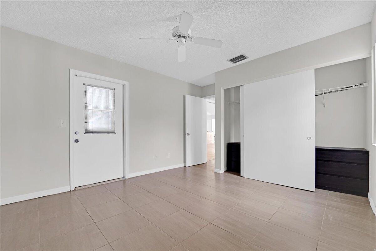 21575 Kapok Circle Boca Raton, FL 33433 - Photo 13 of 27 a view of an empty room with closet and cabinet