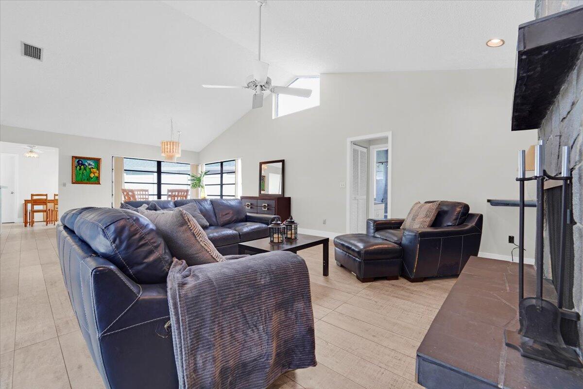 21575 Kapok Circle Boca Raton, FL 33433 - Photo 15 of 27 a living room with furniture a flat screen tv and a fireplace