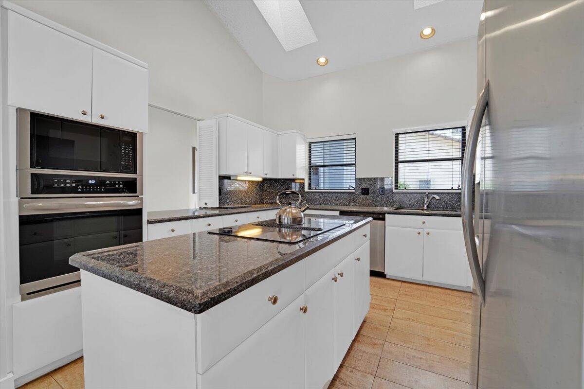 21575 Kapok Circle Boca Raton, FL 33433 - Photo 19 of 27 a kitchen with granite countertop a sink stove and refrigerator