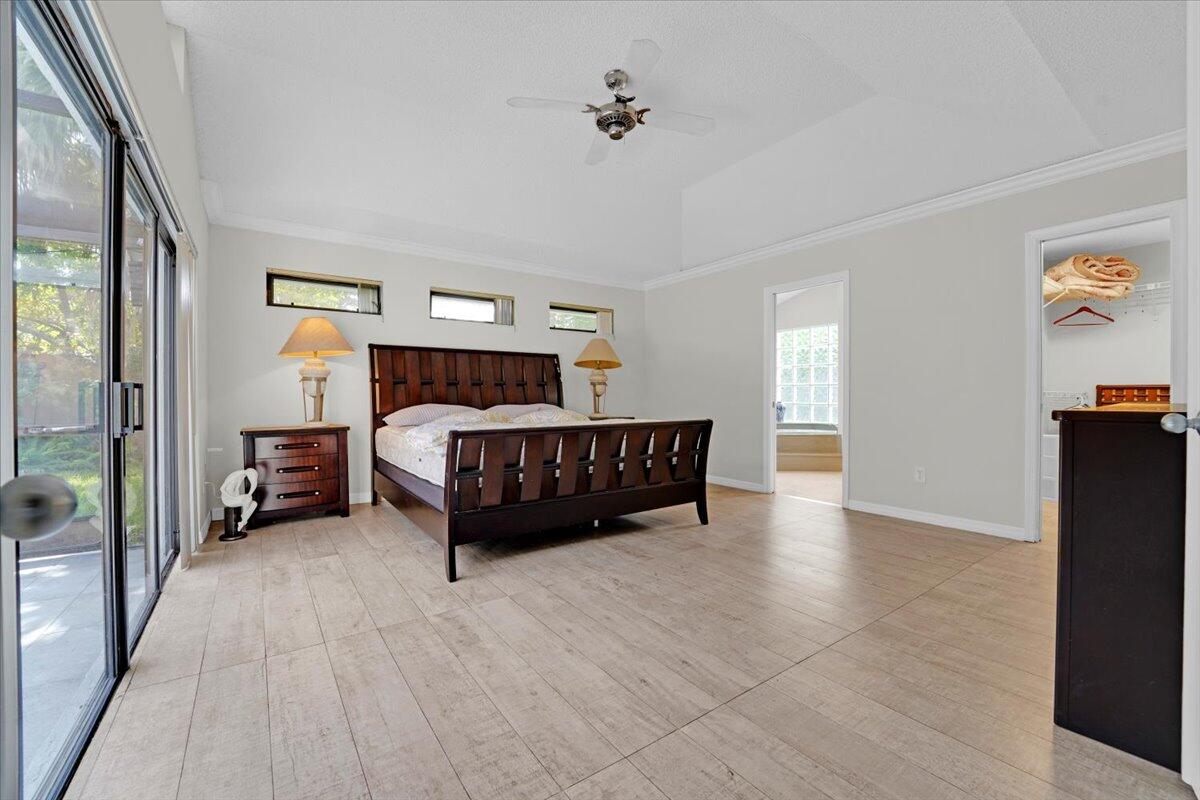 21575 Kapok Circle Boca Raton, FL 33433 - Photo 21 of 27 a bedroom with furniture and a ceiling fan