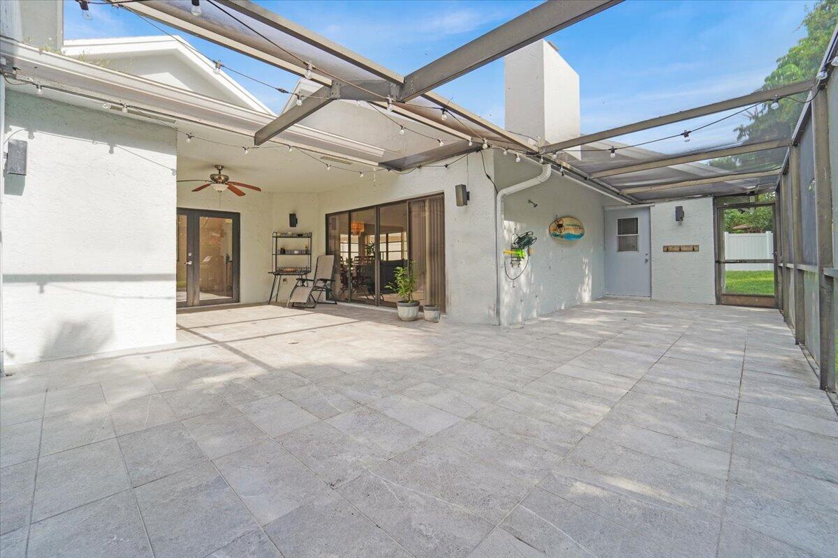 21575 Kapok Circle Boca Raton, FL 33433 - Photo 8 of 27 a view of a hallway with glass door and chandelier