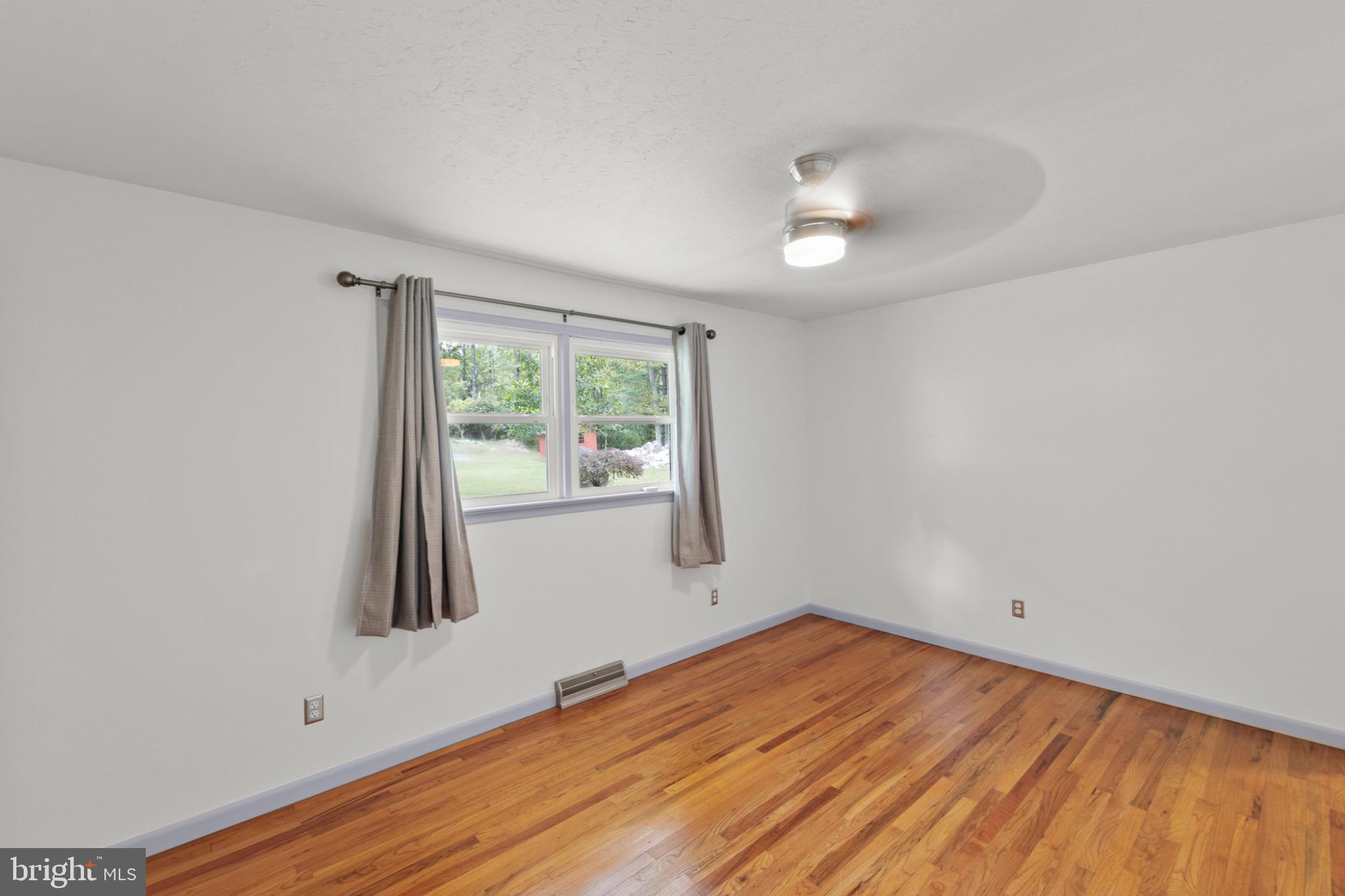 411 Rest Church Road Winchester, VA 22603 - Photo 25 of 46 Bright and airy room with hardwood floors.
