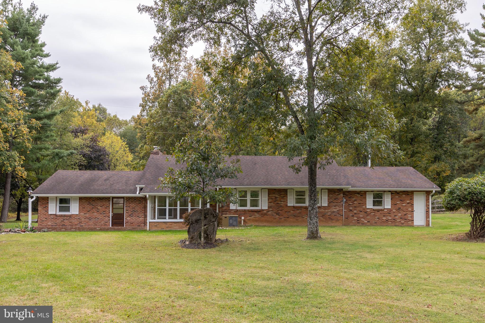 411 Rest Church Road Winchester, VA 22603 - Photo 5 of 46 Charming brick home nestled in lush greenery.
