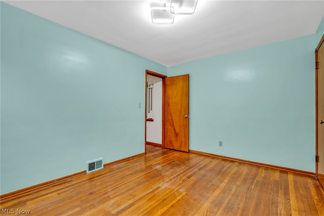 5731 Dunham Road Maple Heights, OH 44137 - Photo 13 of 28 first floor bedroom featuring dark hardwood / wood-style flooring