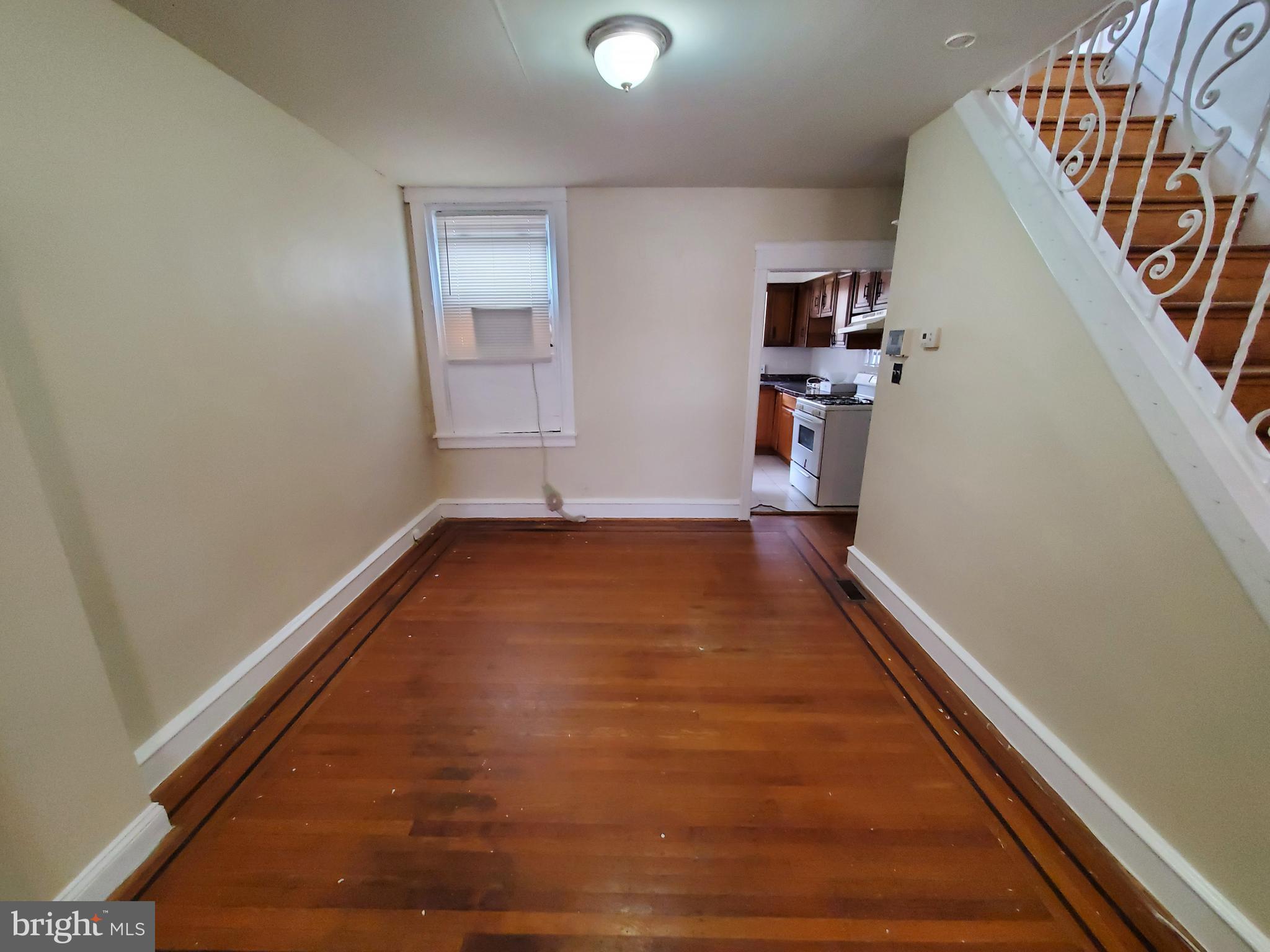 2130 Anchor Street Philadelphia, PA 19124 - Photo 8 of 23 an empty room with wooden floor and staircase