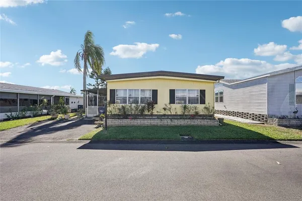 a view of a house with a swimming pool and a yard