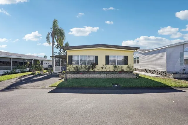 a view of a house with a swimming pool and a yard