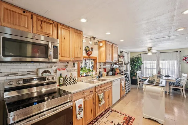 a kitchen with lots of counter top space a sink and appliances