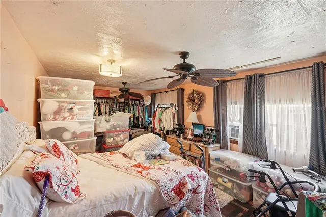 a bedroom with two beds and a chandelier
