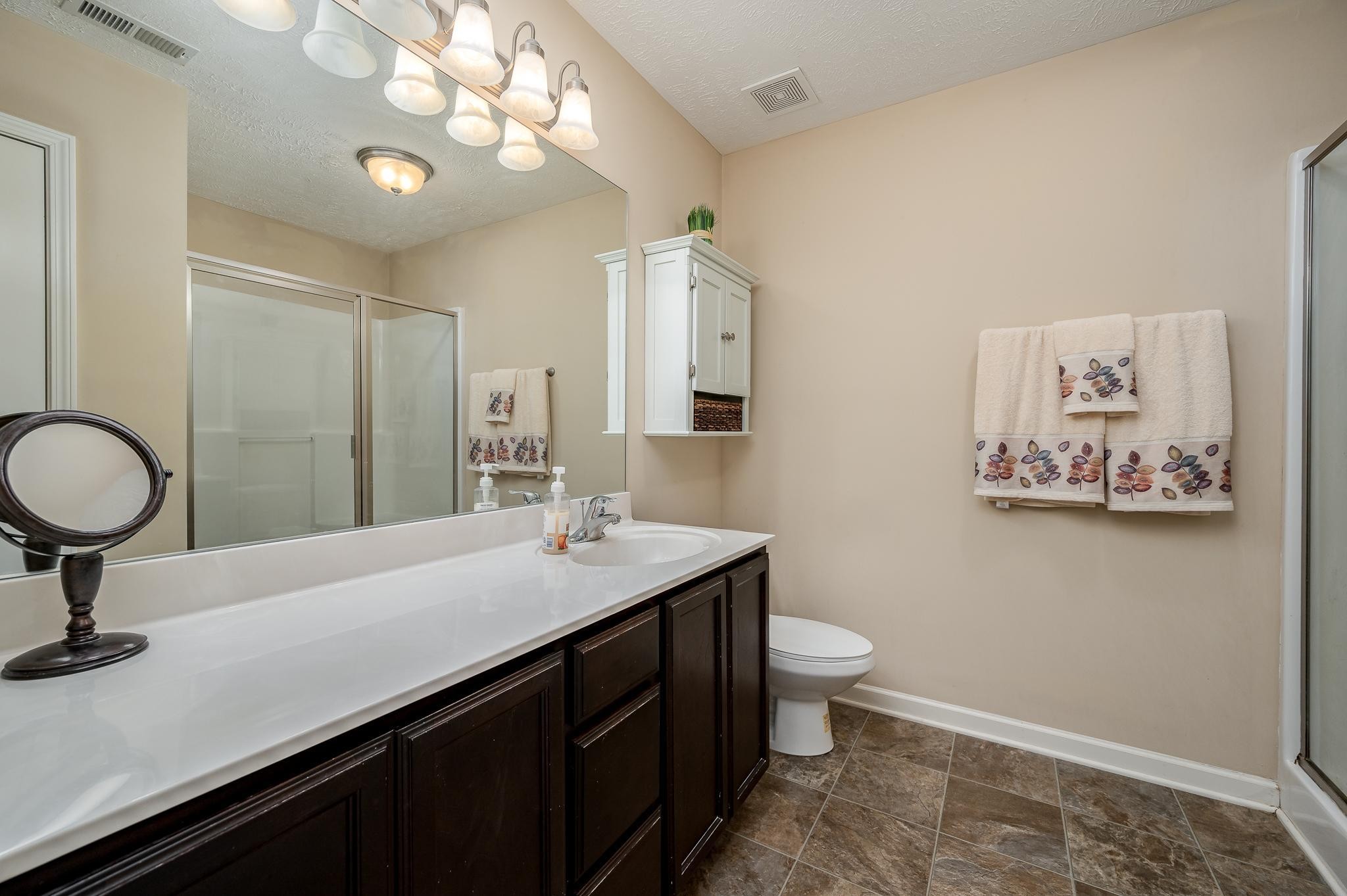 1145 Starhurst Drive Murfreesboro, TN 37128 - Photo 14 of 27 a bathroom with a sink a toilet and a mirror