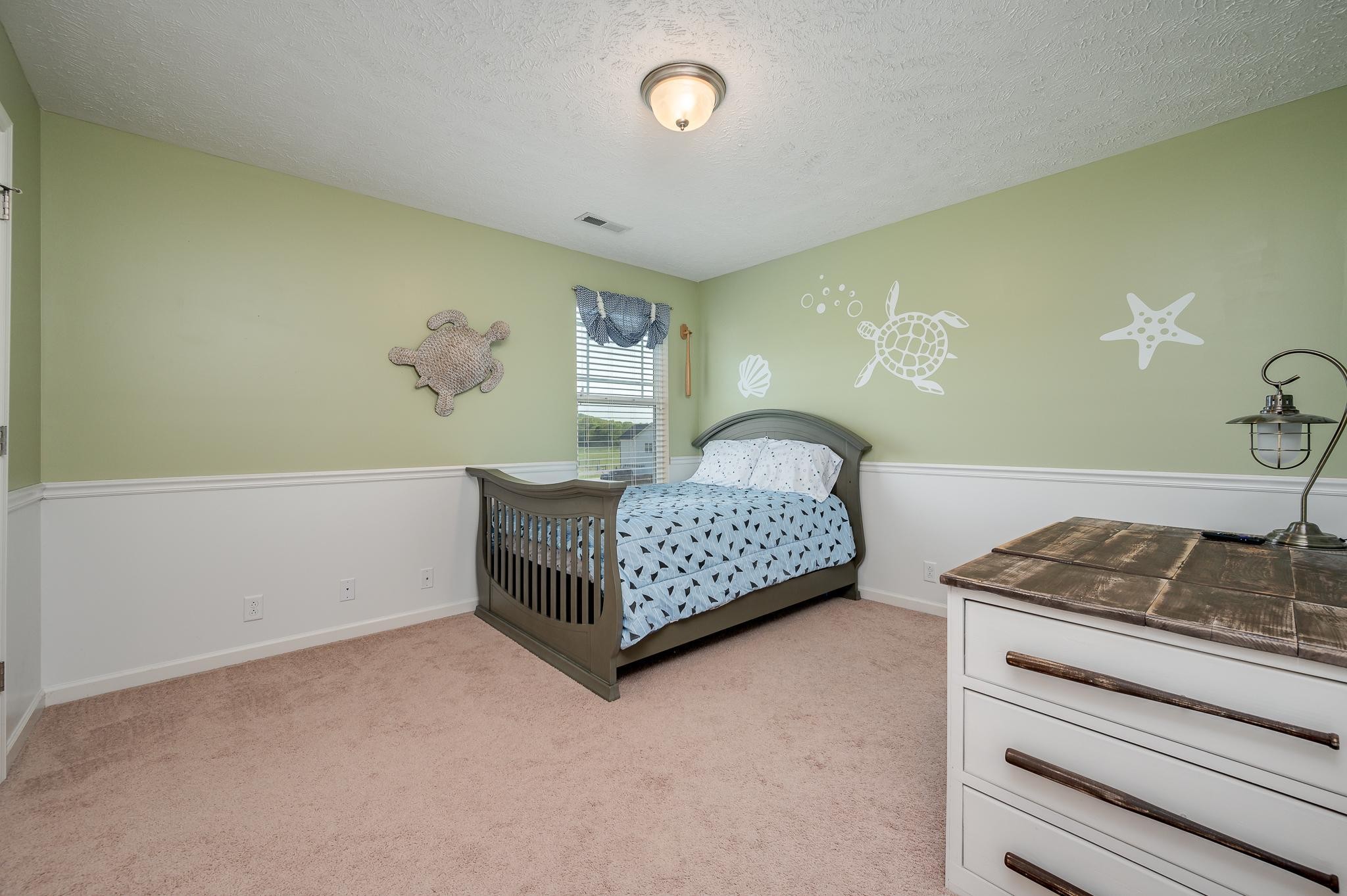 1145 Starhurst Drive Murfreesboro, TN 37128 - Photo 16 of 27 a bedroom with a bed and cabinets