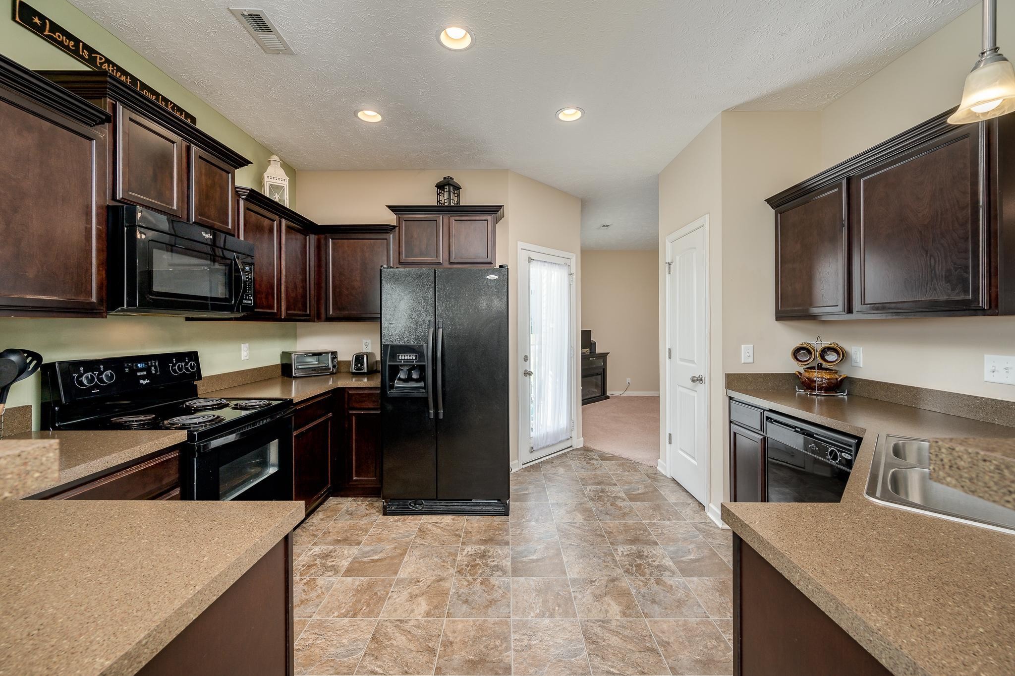 1145 Starhurst Drive Murfreesboro, TN 37128 - Photo 5 of 27 a kitchen with stainless steel appliances granite countertop a refrigerator a stove top oven a sink and dishwasher