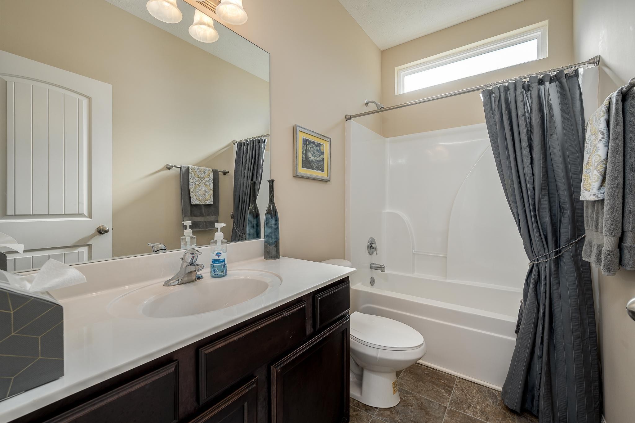 1145 Starhurst Drive Murfreesboro, TN 37128 - Photo 10 of 27 a bathroom with a sink a toilet a tub and shower