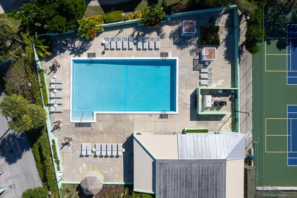 a view of swimming pool with a lounge chairs