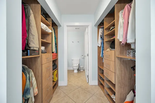 a living room with furniture a couch and a potted plant
