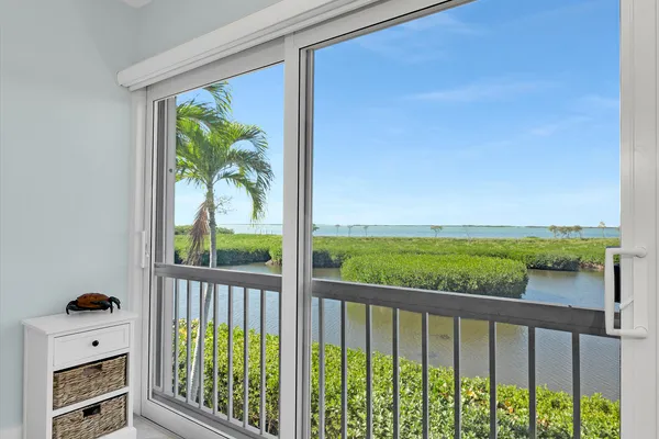 a bedroom with two beds and a window