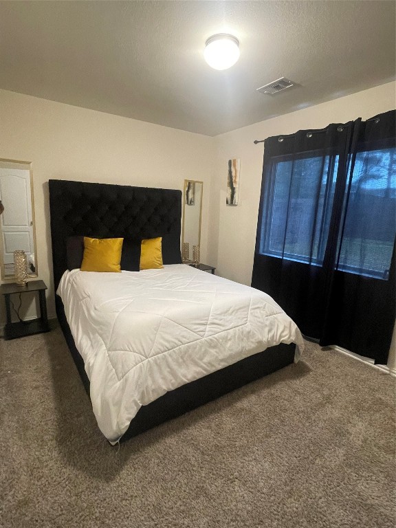 17768 Lion Heart Road Conroe, TX 77306 - Photo 8 of 11 a bedroom with a bed and wooden floor