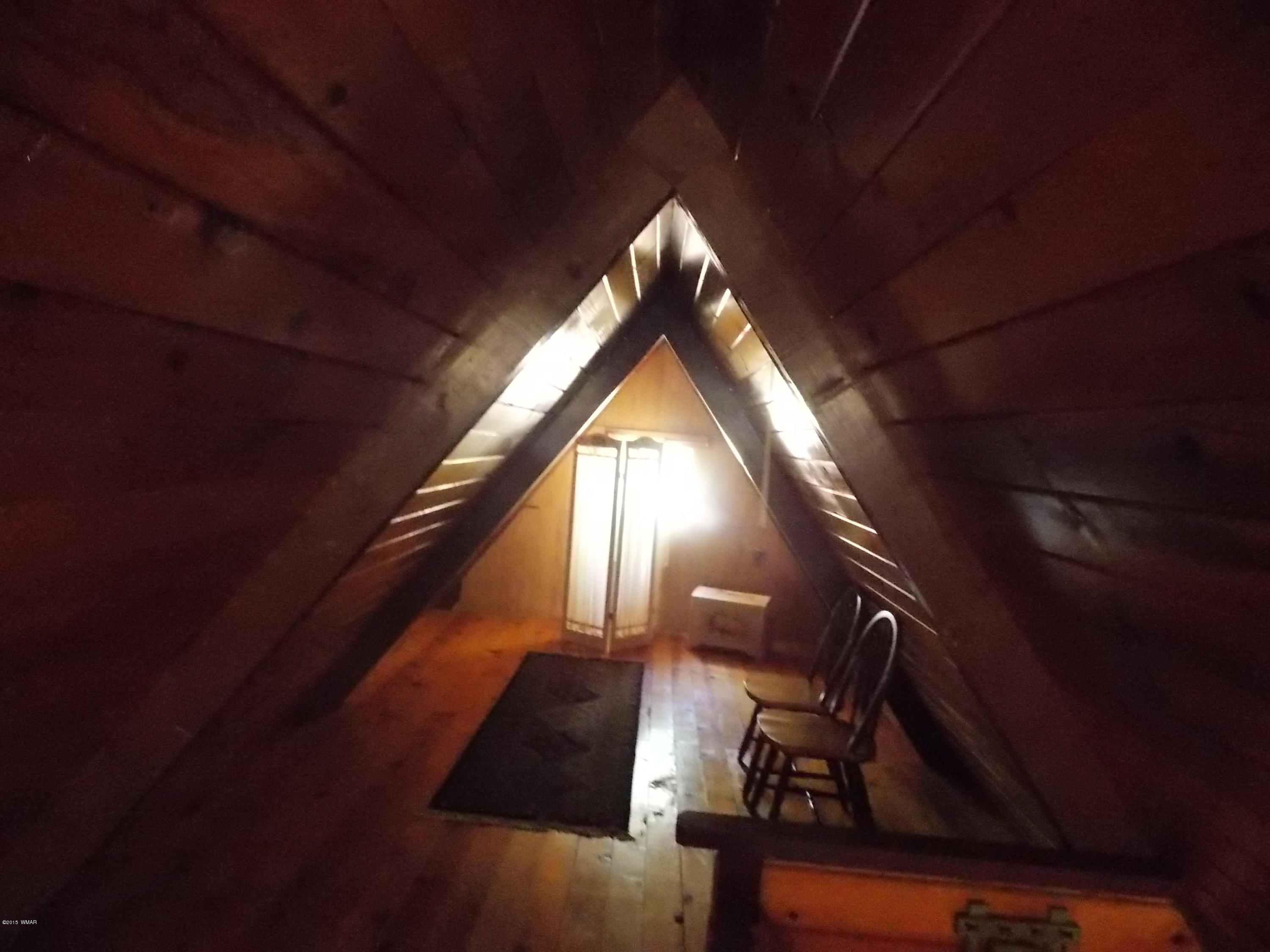 2886 Big Pine Road Overgaard, AZ 85933 - Photo 11 of 25 a view of staircase with wooden floor and furniture