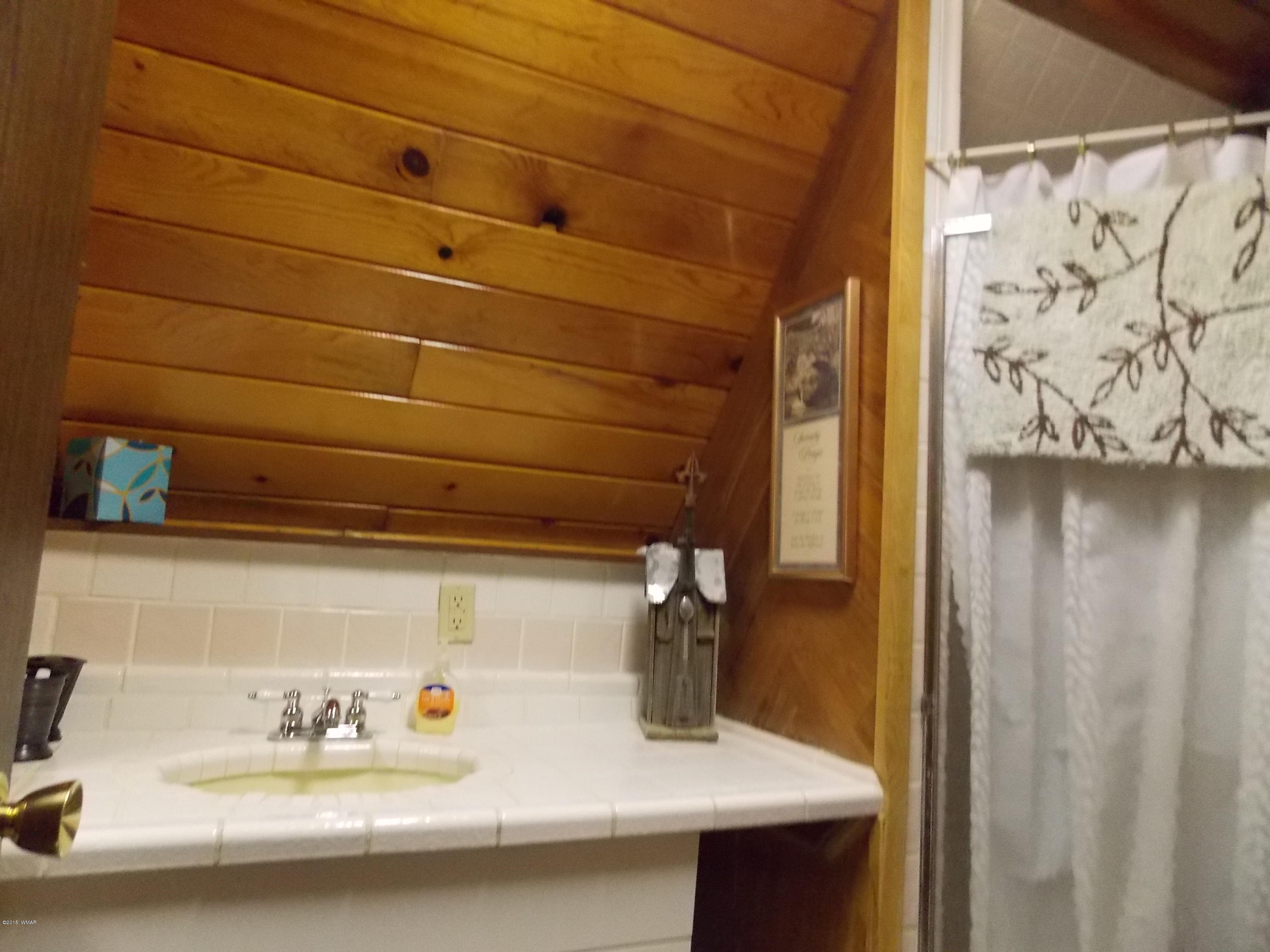 2886 Big Pine Road Overgaard, AZ 85933 - Photo 7 of 25 a bathroom with a sink and a mirror