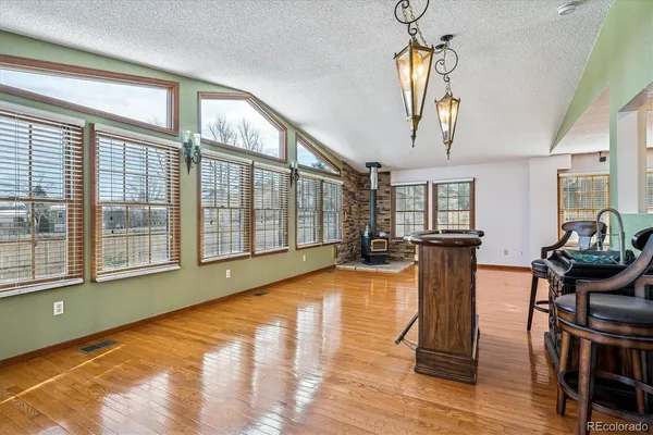 a living room with furniture a flat screen tv and a large window