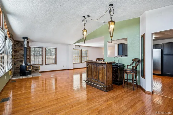 a large hall with wooden floor and windows
