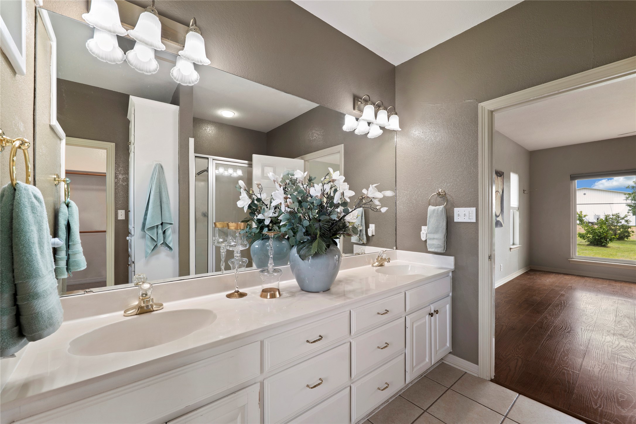 1005 East Buttercup Road Taylor, TX 76574 - Photo 12 of 38 a bathroom with a double vanity sink and a mirror