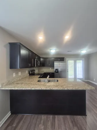 a kitchen with a sink and a refrigerator