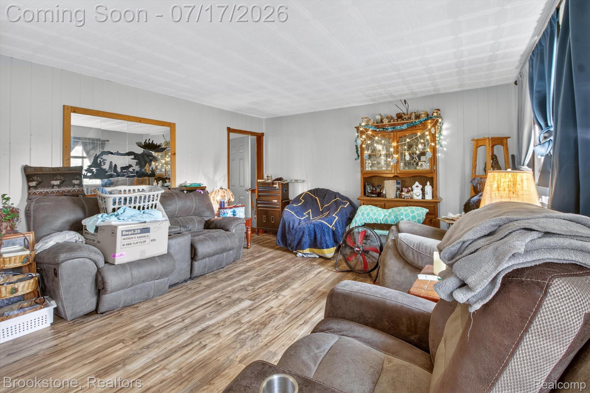 22709 Pleasant Valley Road Hillman, MI 49746 - Photo 11 of 42 Wood-finish flooring throughout the room with light-toned paneled walls