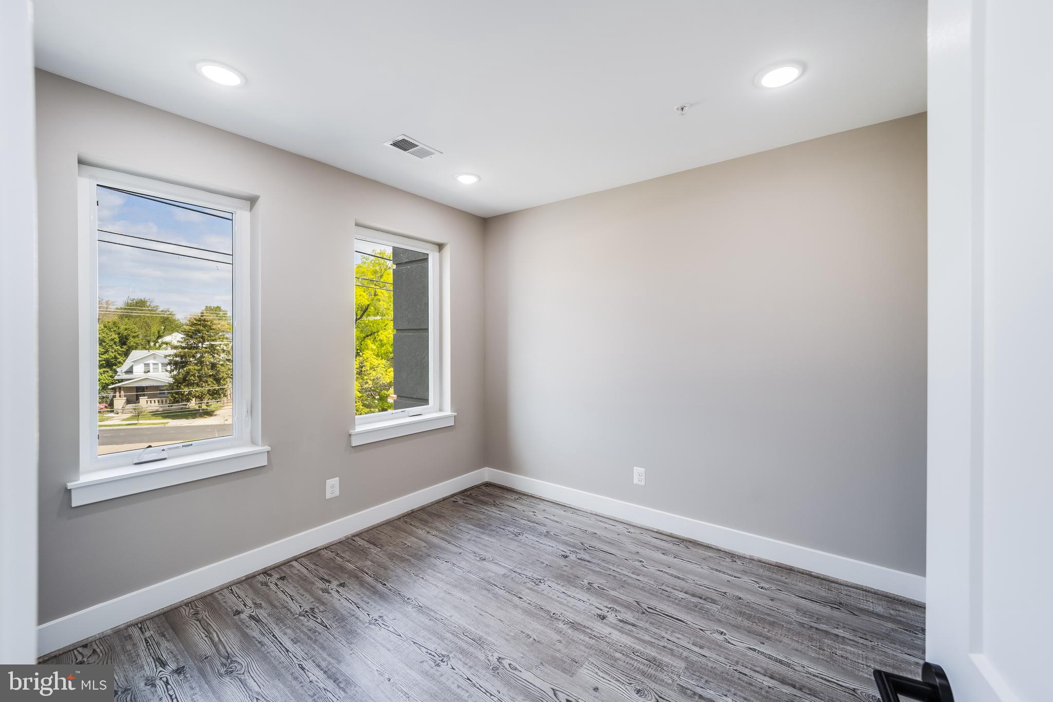 1617 Rhode Island Avenue Northeast, Unit 501 Washington, DC 20018 - Photo 11 of 17 wooden floor in an empty room with a window