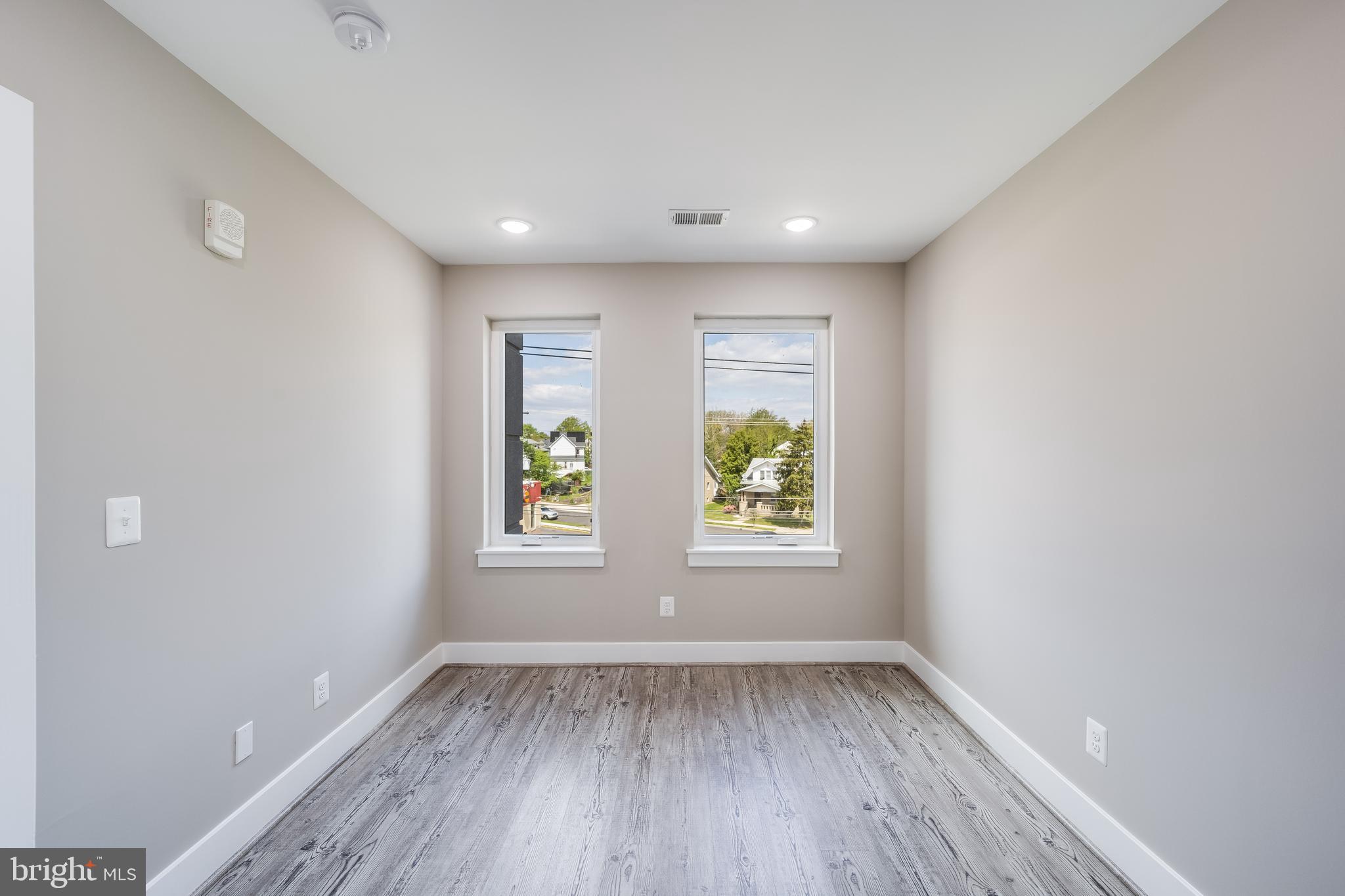1617 Rhode Island Avenue Northeast, Unit 501 Washington, DC 20018 - Photo 12 of 17 an empty room with wooden floor and window