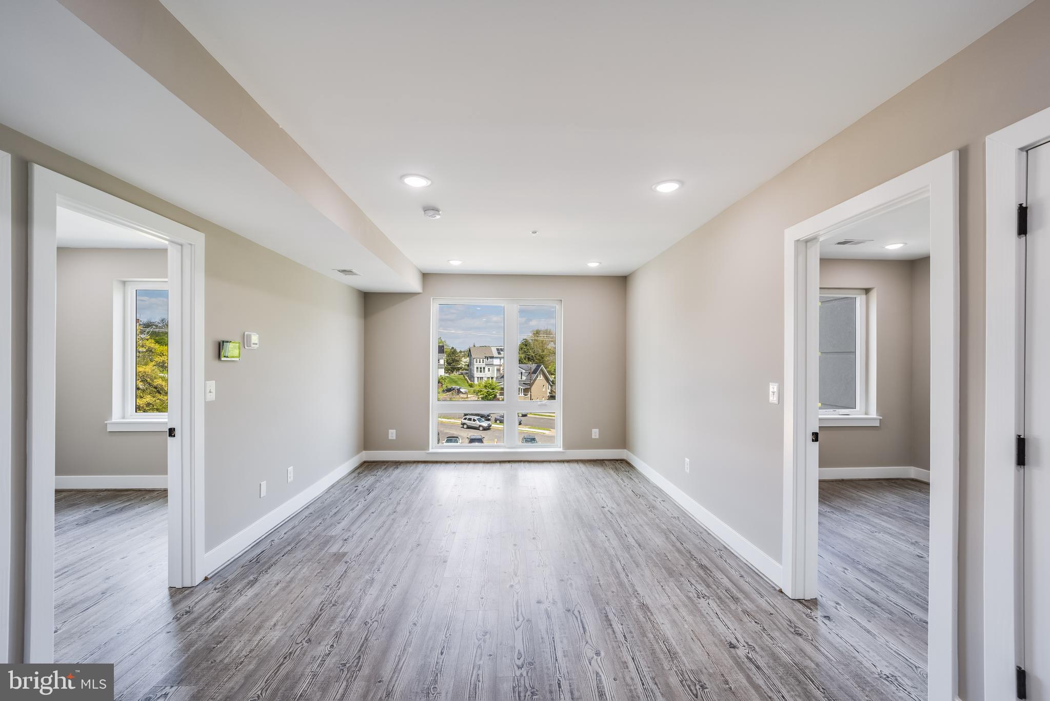 1617 Rhode Island Avenue Northeast, Unit 501 Washington, DC 20018 - Photo 3 of 17 a view of an empty room with wooden floor and a window