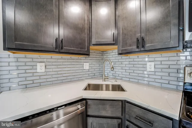 a kitchen with a sink and cabinets
