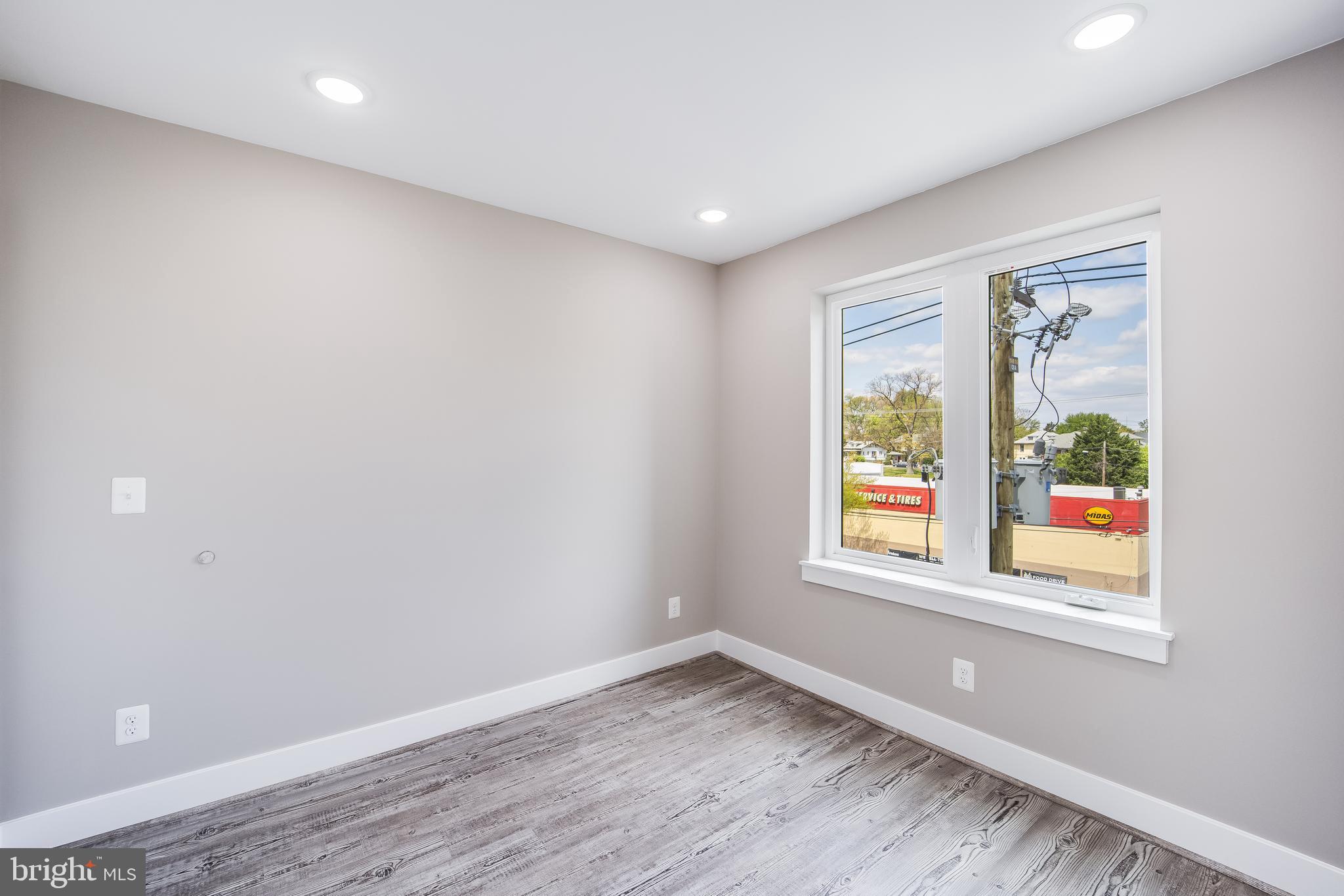 1617 Rhode Island Avenue Northeast, Unit 501 Washington, DC 20018 - Photo 10 of 17 an empty room with wooden floor and windows