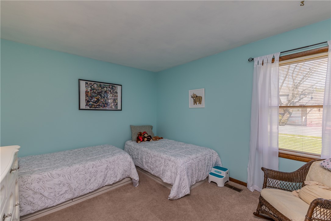 4210 Pleasanton Road Englewood, OH 45322 - Photo 22 of 34 This cozy bedroom features soft carpeting and a bright window, creating a serene and inviting atmosphere.
