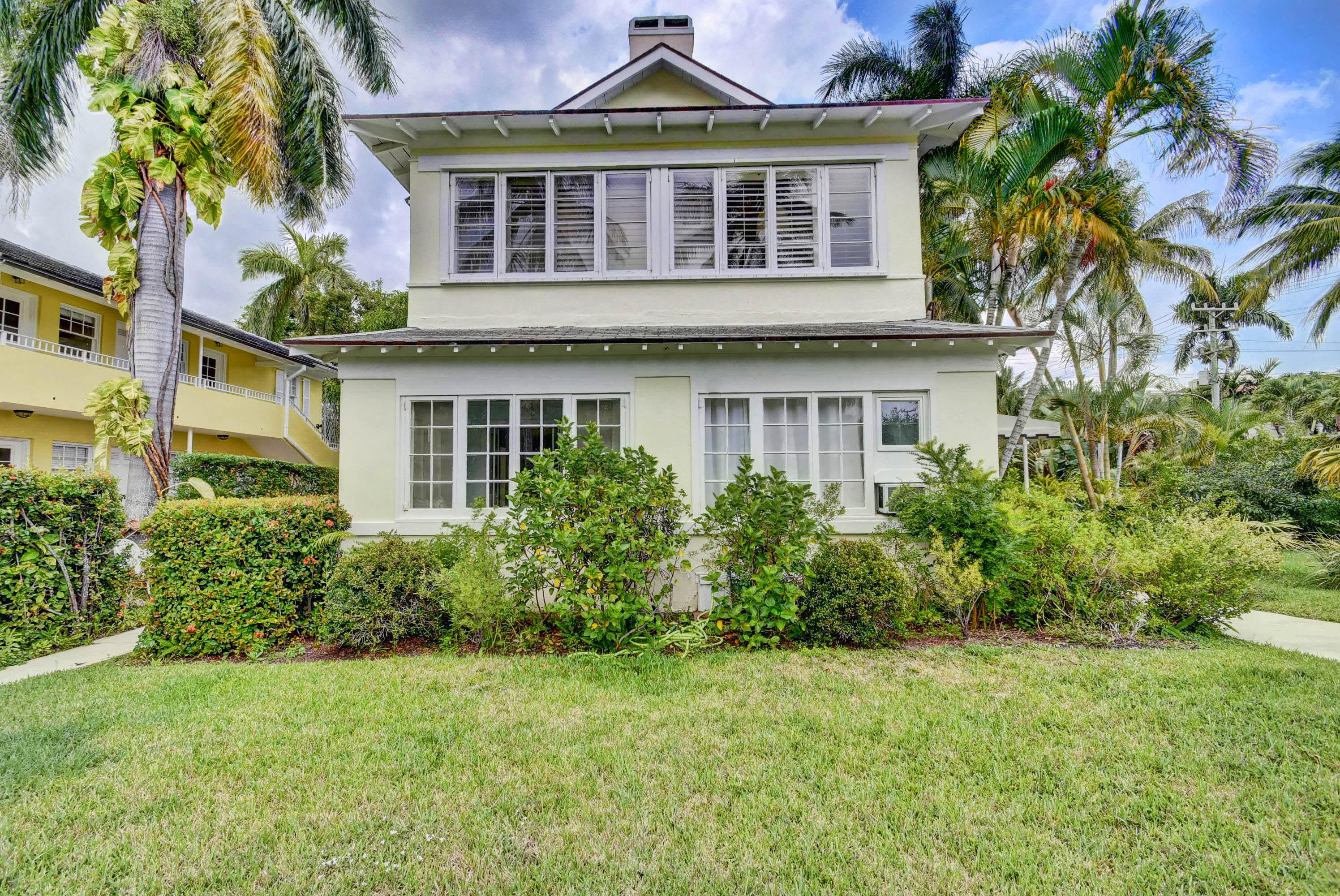 301 Chilean Avenue, Unit 80 Palm Beach, FL 33480 - Photo 2 of 20 a front view of a house with a garden