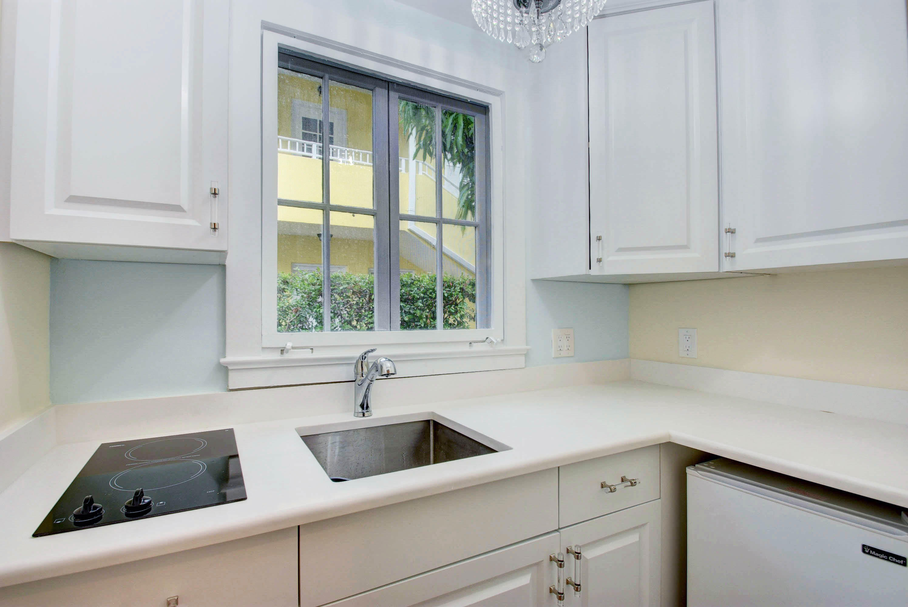 301 Chilean Avenue, Unit 80 Palm Beach, FL 33480 - Photo 13 of 20 a kitchen with white cabinets and a sink