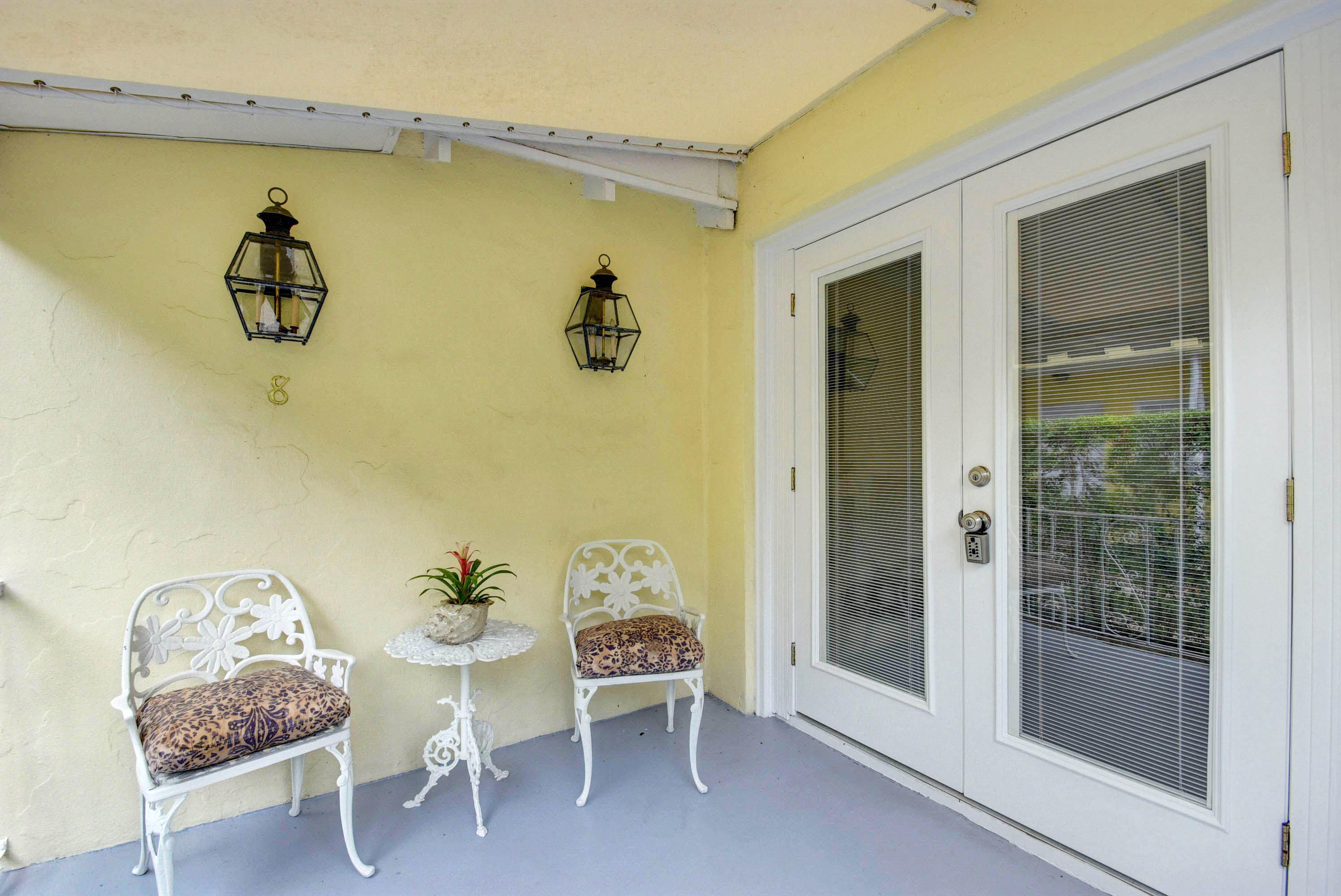 301 Chilean Avenue, Unit 80 Palm Beach, FL 33480 - Photo 5 of 20 a view of a dining room with furniture and front door