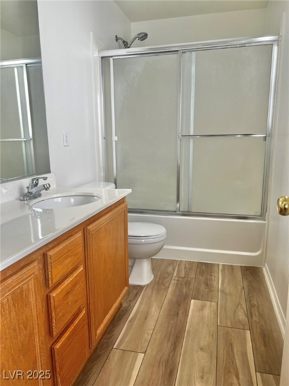 3153 Amari Avenue Las Vegas, NV 89141 - Photo 15 of 21 Bathroom with vanity, wood finished floors, and combined bath / shower with glass door