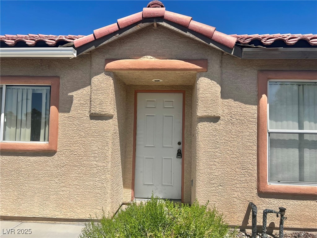3153 Amari Avenue Las Vegas, NV 89141 - Photo 2 of 21 Property entrance featuring stucco siding and a tile roof
