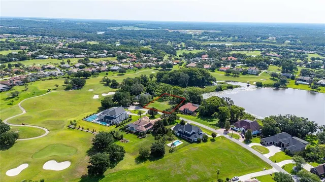 an aerial view of ocean and residential houses with outdoor space