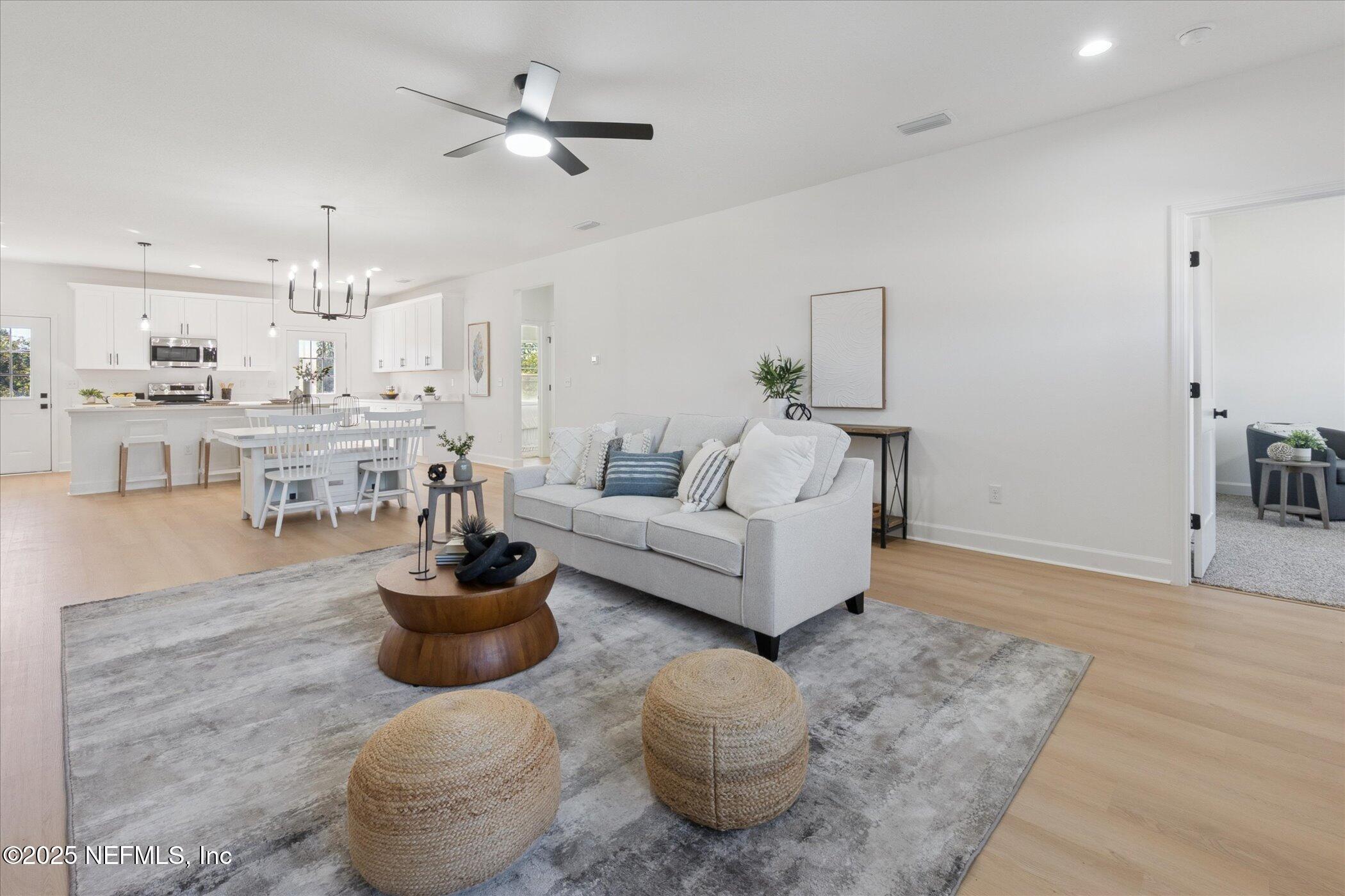 9293 Dolphin Street Sanderson, FL 32087 - Photo 11 of 29 a living room with furniture and a chandelier