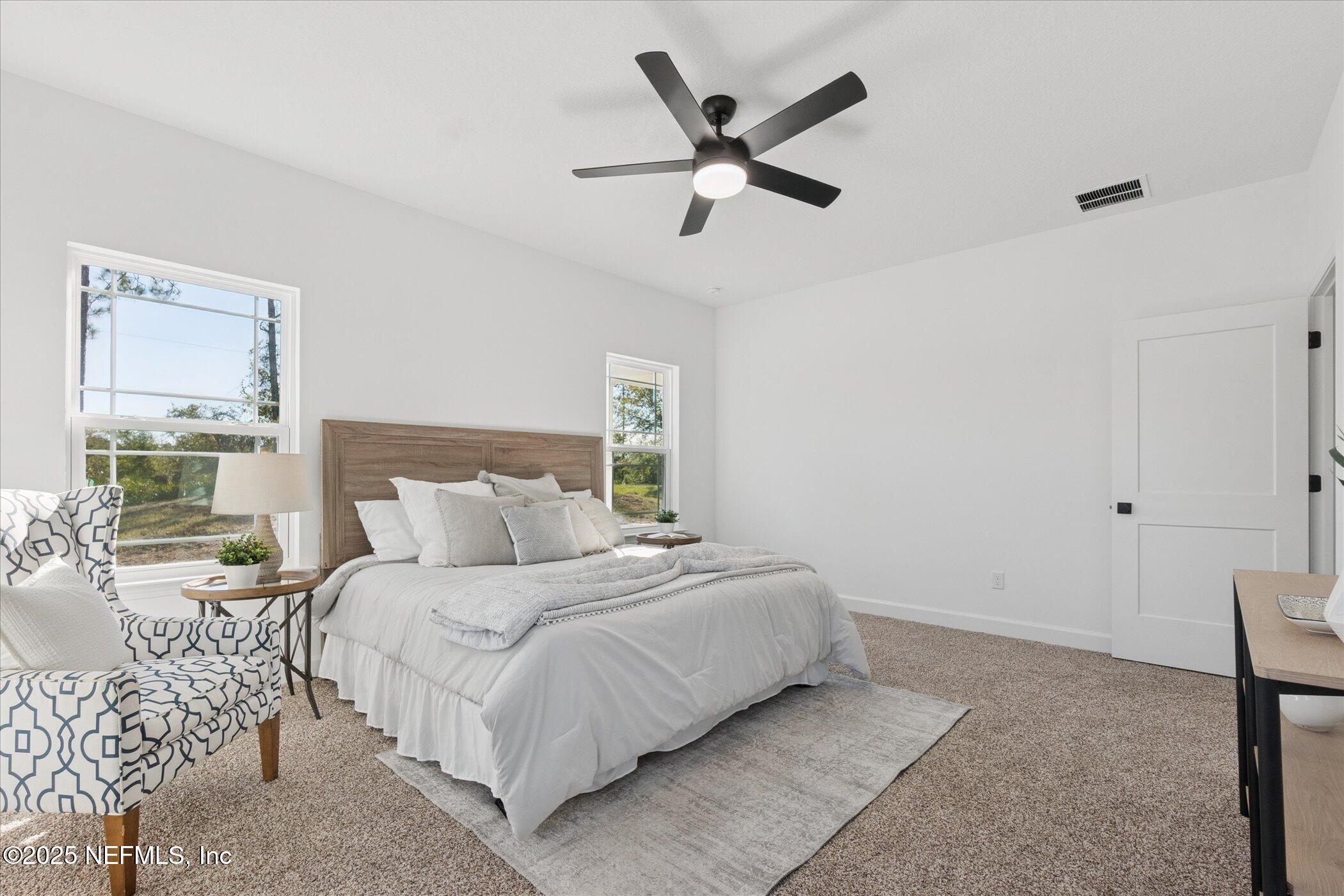 9293 Dolphin Street Sanderson, FL 32087 - Photo 15 of 29 a bedroom with a large bed and a large window