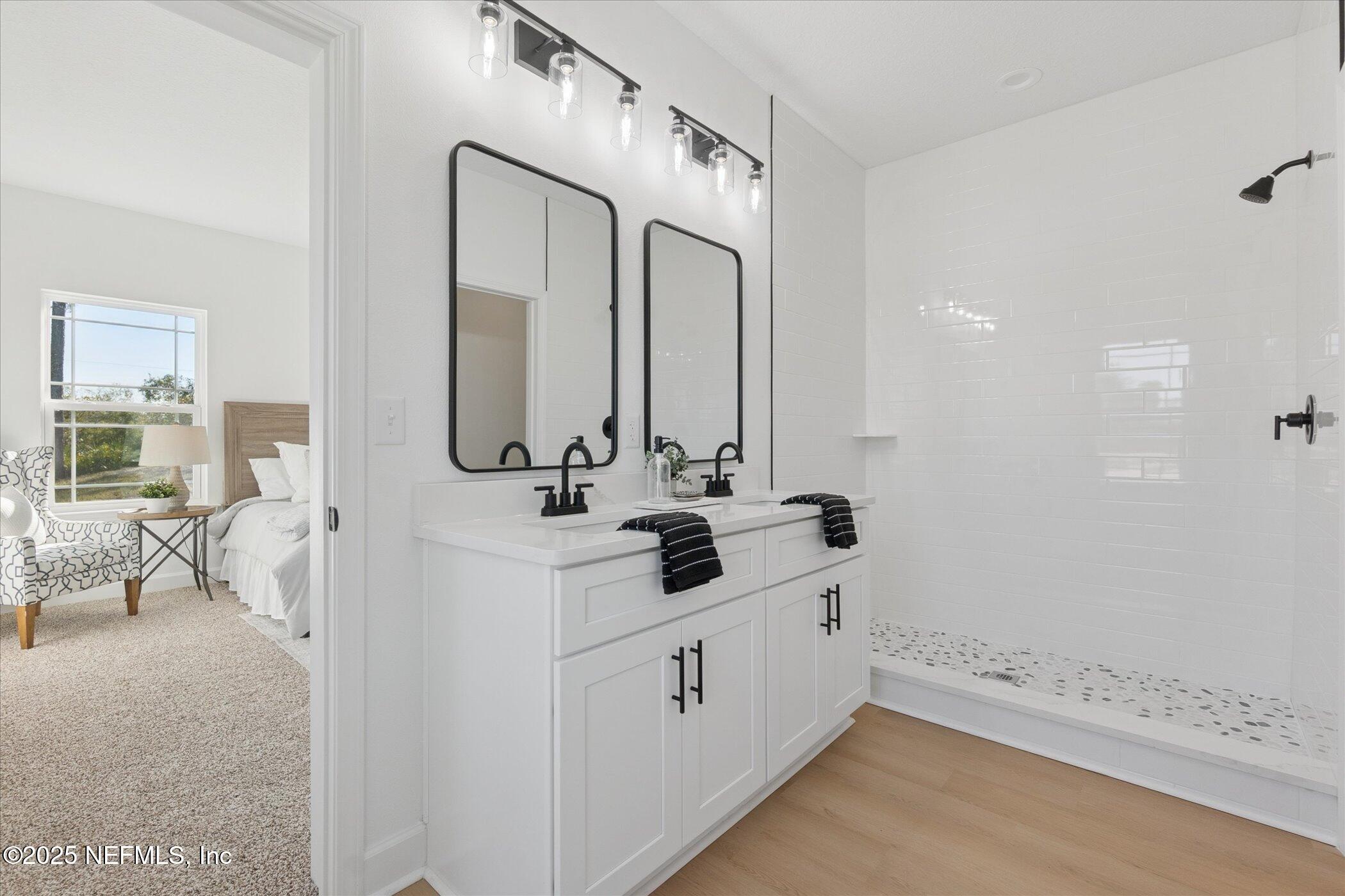 9293 Dolphin Street Sanderson, FL 32087 - Photo 17 of 29 a bathroom with a double vanity sink mirror and