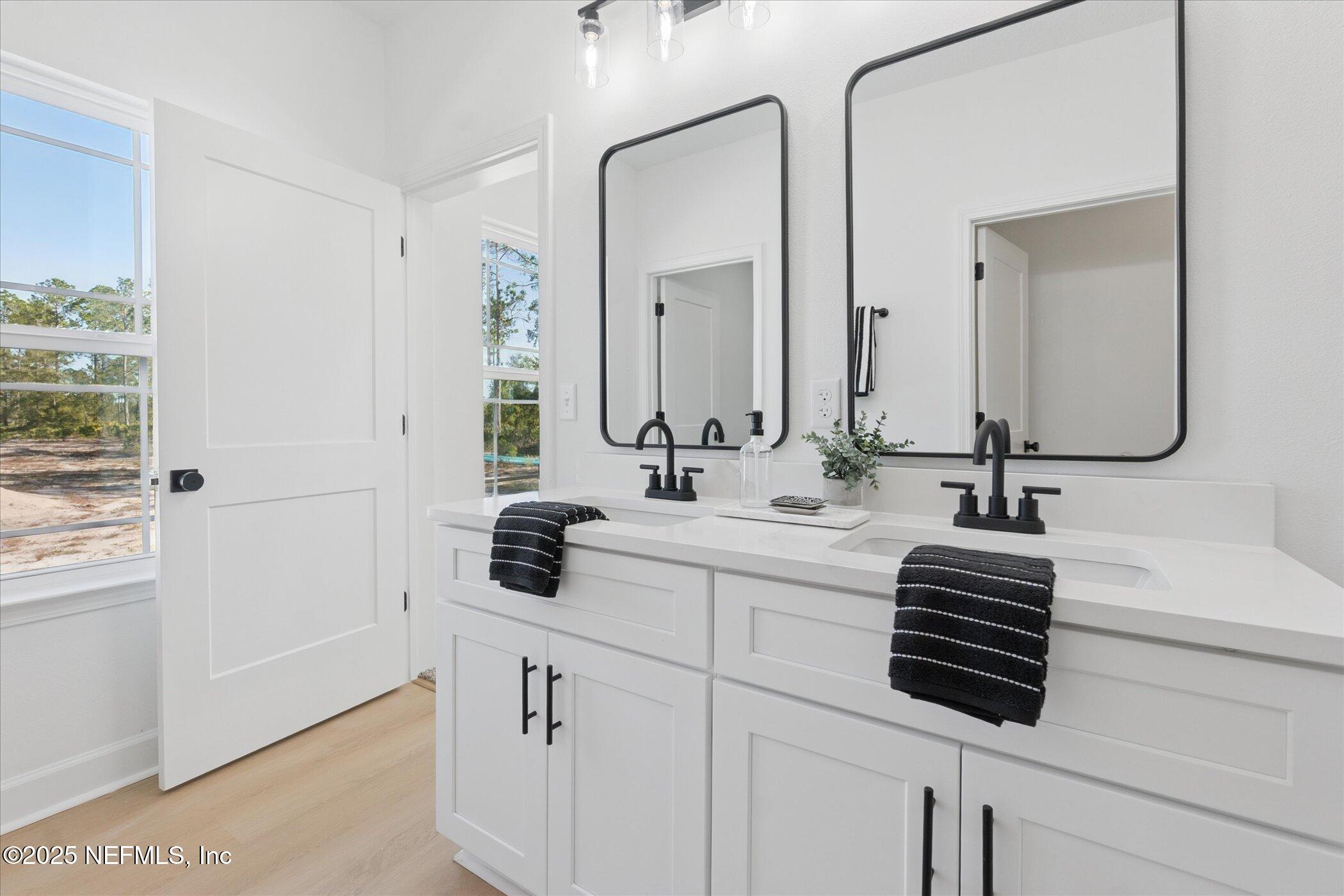 9293 Dolphin Street Sanderson, FL 32087 - Photo 18 of 29 a bathroom with a sink and a mirror
