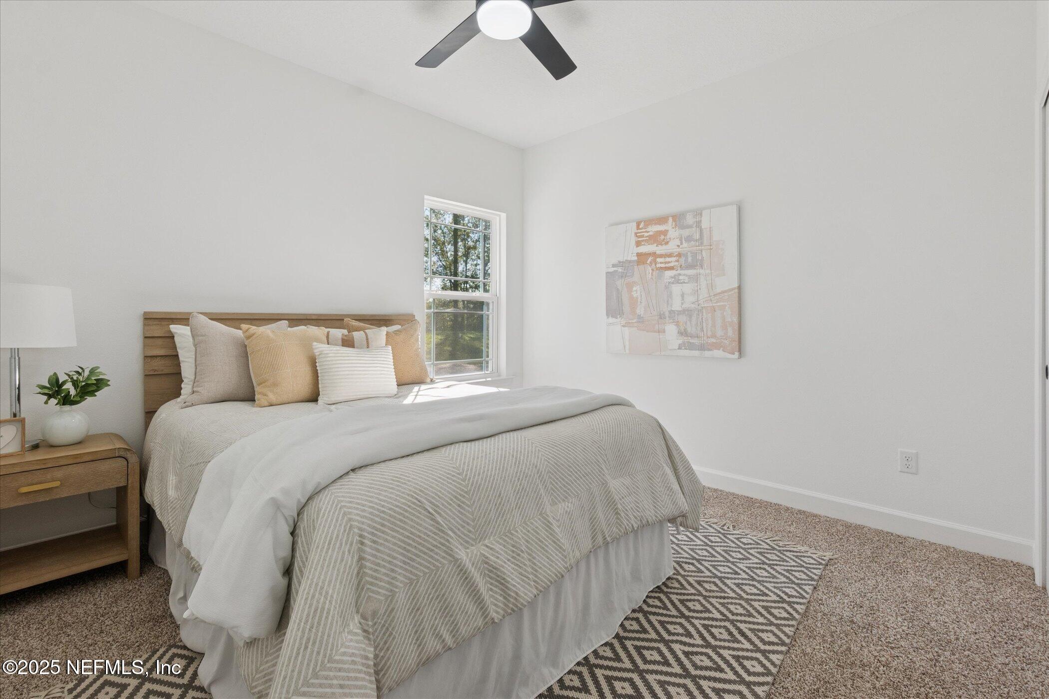 9293 Dolphin Street Sanderson, FL 32087 - Photo 19 of 29 a bedroom with a bed and painting on the wall