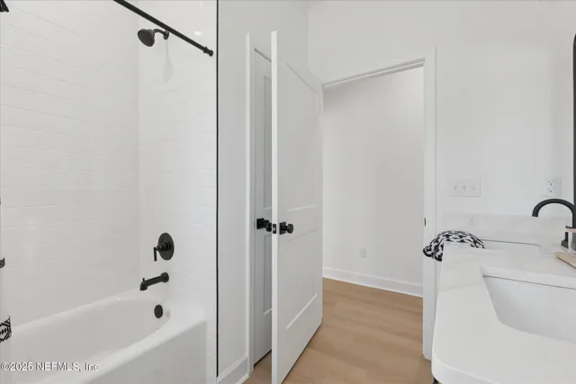 a bathroom with a bathtub and a shower