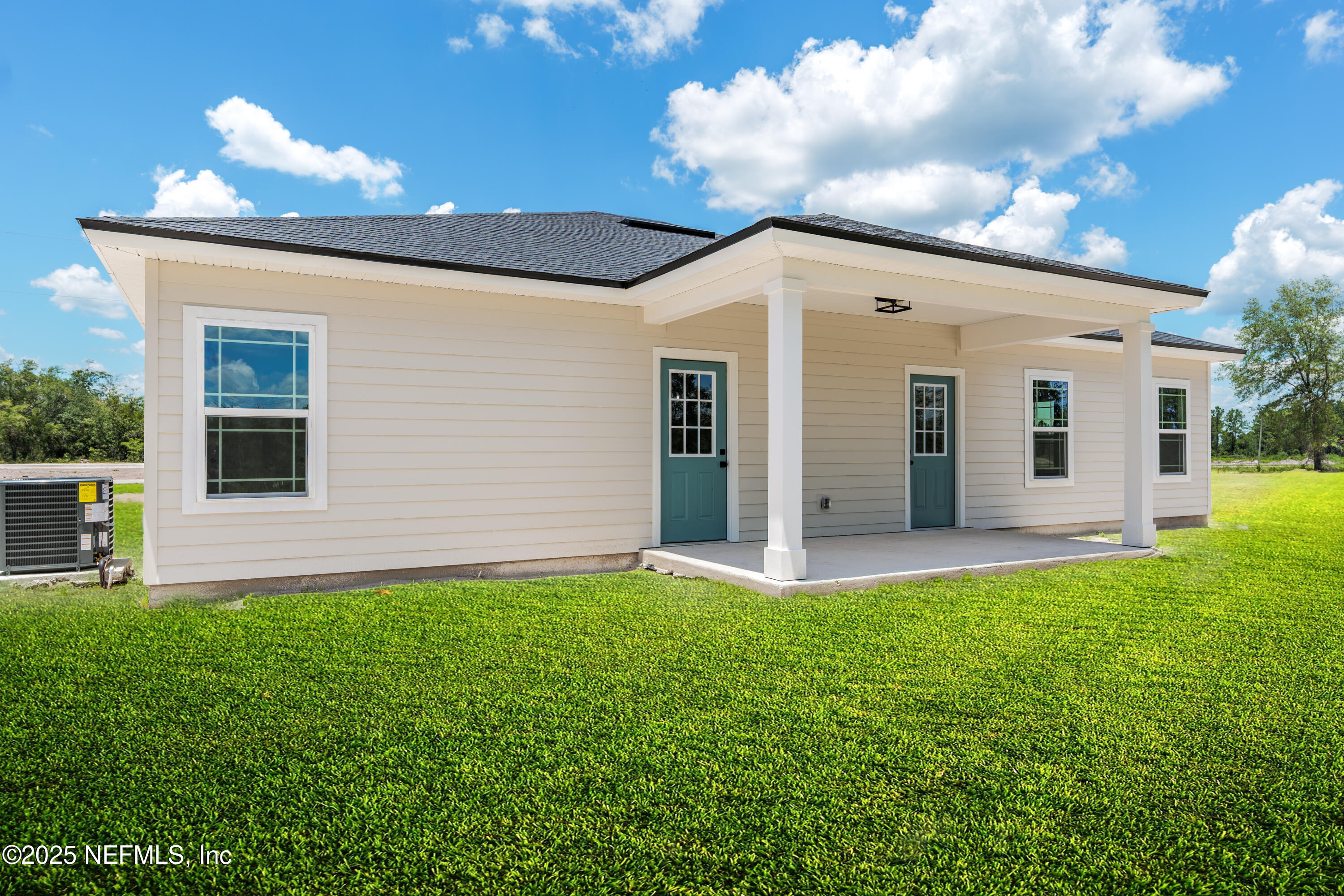 9293 Dolphin Street Sanderson, FL 32087 - Photo 27 of 29 a backyard of a house with table and chairs