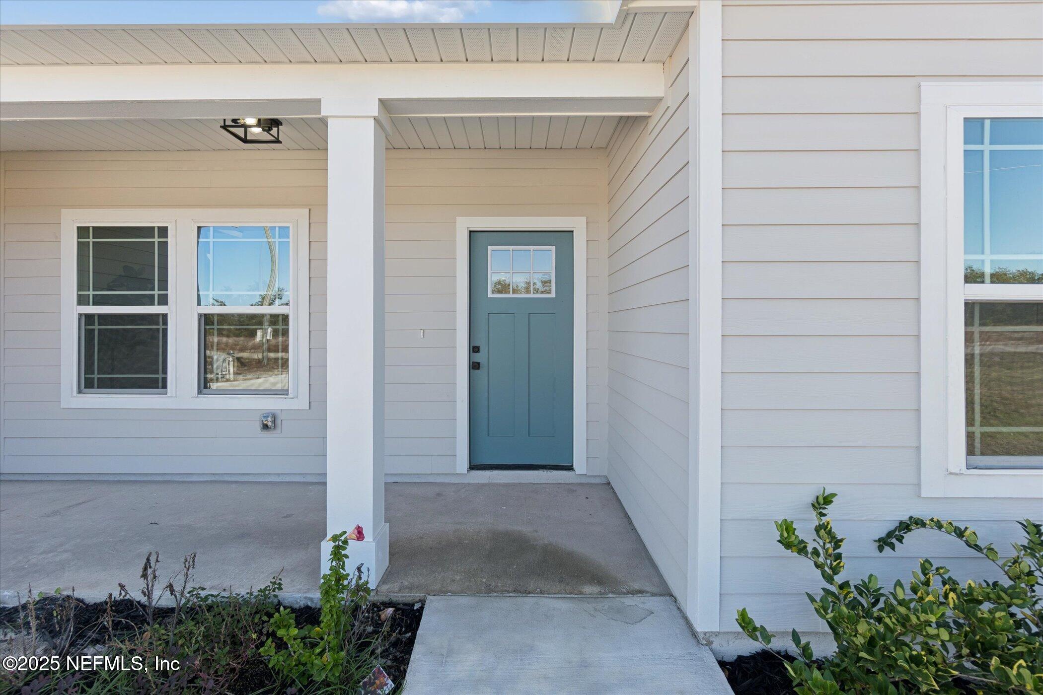 9293 Dolphin Street Sanderson, FL 32087 - Photo 3 of 29 a view of a pathway besides a house
