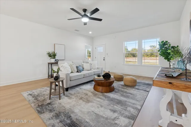 a living room with furniture a chandelier and a window