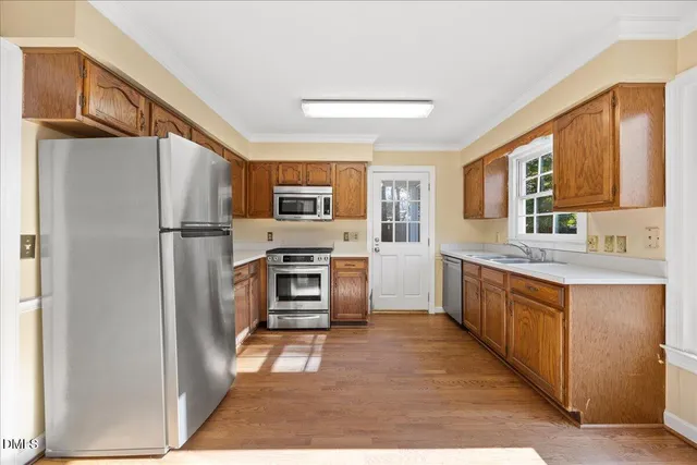 a kitchen with stainless steel appliances a refrigerator stove microwave and sink